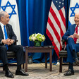 Benjamin Netanyahu and Joe Biden, seated, with US and Israeli flags behind them