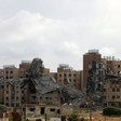 A group of destroyed buildings against a cloudy sky