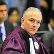 British lawyer Andrew Cayley wearing purple and white robes 