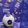 A football beside posters saying Use Your Vote in a number of languages 