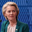 European Commission President Ursula von der Leyen seated in front of a blue backdrop 