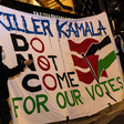 Two protesters stand alongside a banner that says Killer Kamala Do Not Come for our votes outside the DNC in Chicago, Illinois