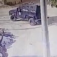 Two teens on a motorcycle parked feet away from armored vehicle 