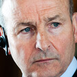 A portrait of Ireland's Foreign Minister Micheal Martin wearing earphones