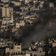 Smoke rises amid a dense residential area 