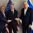 Israeli politician Gadi Eisenkot stands beside then US Secretary of State Antony Blinken and Benny Gantz, another Israeli politician, with flags behind them 