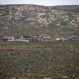 Landscape view of a collection of trailer and structures in a field 