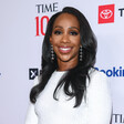 CNN anchor Abby Phillip at TIME 100 Gala with names of the event’s associated corporate partners behind her