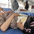 A Palestinian child rests in a hospital bed with tubes connected to his abdomen and nose