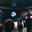 People look at a screen with the words Paris Space Hub projected on it