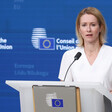 The European Union's foreign policy chief Kaja Kallas stands at a lectern with a microphone