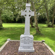 A Celtic cross surrounded by trees 