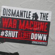 A poster reading Dismantle the War Machine Shut Elbit Down 