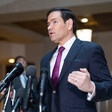 Secretary of State Marco Rubio speaks into multiple microphones in Capitol Building basement