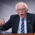 Senator Bernie Sanders gesticulates behind a podium