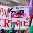 A placard reading Stop the Genocide 