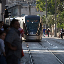 Passengers wait as light rail train approaches