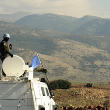 UN soldier atop armored vehicle overlooks Lebanon-Israel border
