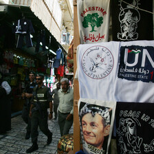 Israeli police walk by display of T-shirts marketed to tourists