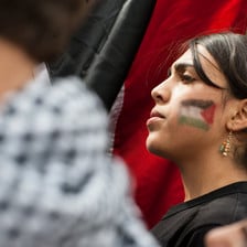 Portrait of girl with flag of Palestine painted on her face