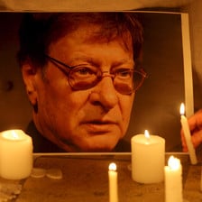Portrait of Mahmoud Darwish illuminated by candles