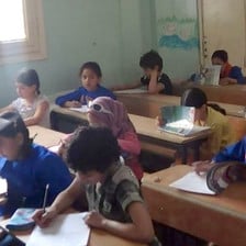 Children sit at school desks