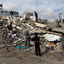Children gather on rubble of building hit in Israeli air strike