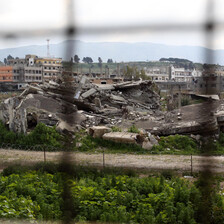 Landscape view of large patch of rubble in middle of refugee camp