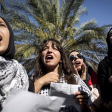 Palestinian women shout during a demonstration