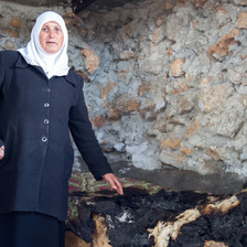 Woman stands in burned-out room