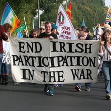 People march while carrying banner reading End Irish Participation In The War