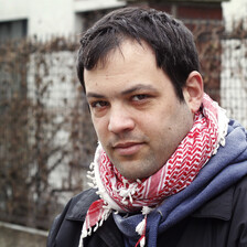 Portrait of young man wearing checkered traditional Palestinian scarf