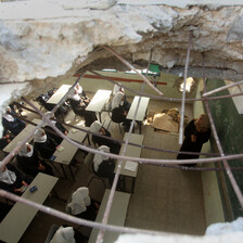 Aerial view of a classroom with a hole in the roof and in one of the walls