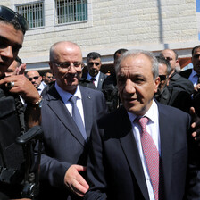 Bodyguards surround Rami Hamdallah and Majid Faraj