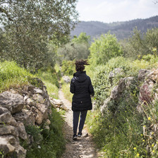 Girl seen from behind walking on path