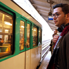 Portrait of young man standing at a train platform