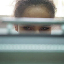 Sanabel, 14, is seen through a slit of her braille typewriter on which she is working during a class at the Peace Center for the Blind in occupied East Jerusalem.