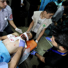 A wounded Palestinian protester is carried on a stretcher.