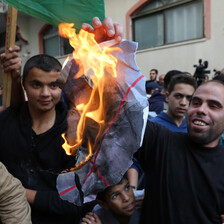 A protestor is seen burning a poster of Avigdor Lieberman, the hardline Israeli politician who resigned over the Israeli response to last week's violence in and around Gaza. The celebratory protests took place outside the home of Hamas leader Ismail Hani