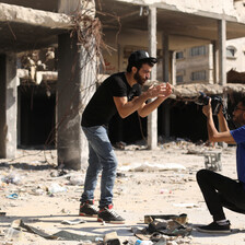 Omar Elemawi films Palestinian rapper Ibrahim Ghunaim (MC Gaza) in front of destroyed buildings in Gaza City