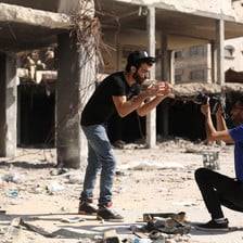 Omar Elemawi films Palestinian rapper Ibrahim Ghunaim (MC Gaza) in front of destroyed buildings in Gaza City