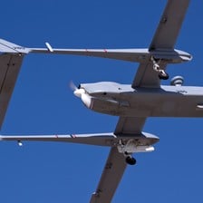 An Unmanned Aerial Vehicle is seen against a blue sky
