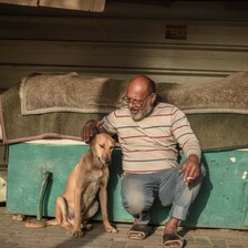 A man pets a dog