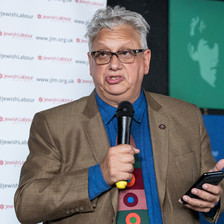 A man holding a microphone and a cell phone
