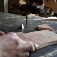 A hand holds a piece of wood