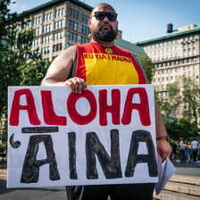 Man holds placard 