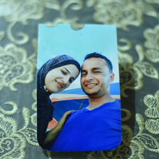 A color photo of a smiling couple lies on a table