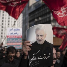 People demonstrate with flags and posters