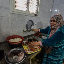 A woman near her kitchen sink