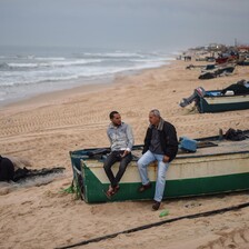 Two men sit on boat